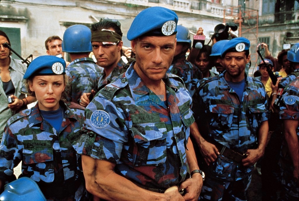 Jean-Claude Van Damme as Colonel Guile leading a group of Allied Nations soldiers, including Cammy (Kylie Minogue), as they prepare for battle against General Bison.