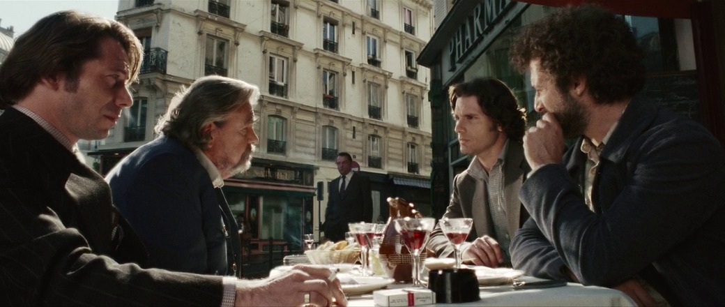 A tense meeting scene where Israeli intelligence operatives, led by Avner Kaufman (Eric Bana), discuss their next move while tracking those responsible for the Munich Olympics attack.