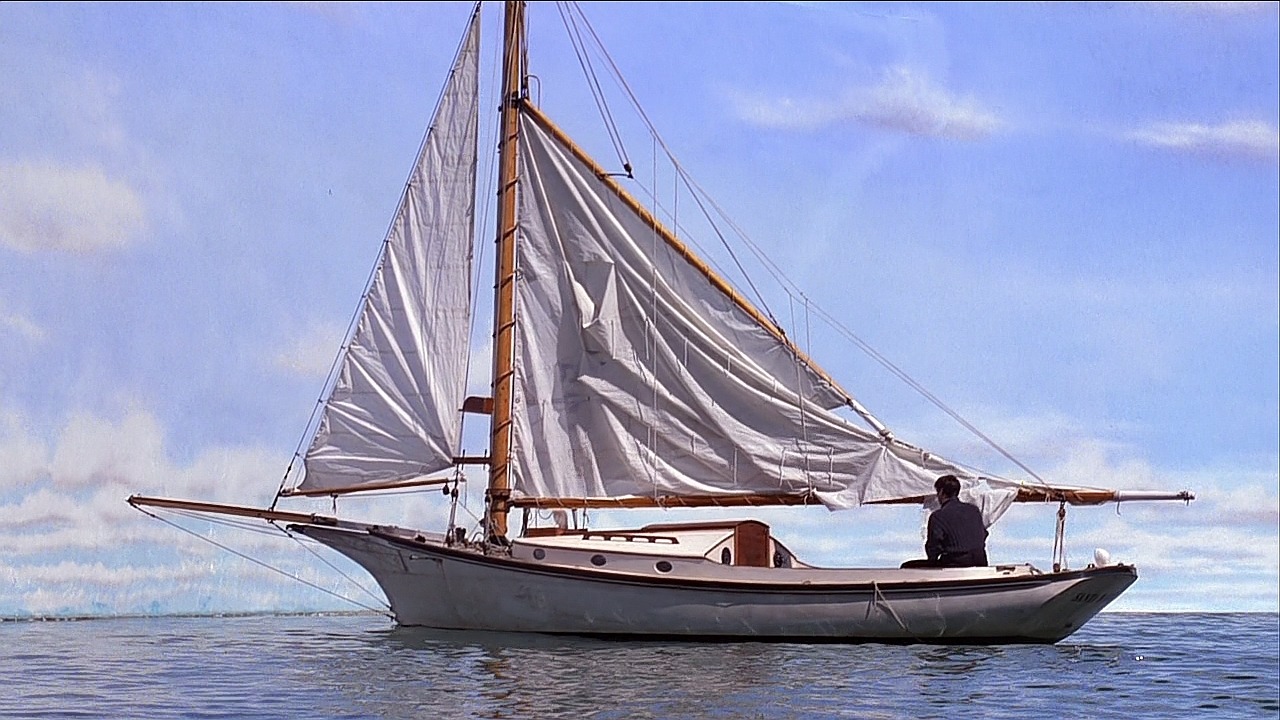 Truman in a small boat trying to escape the world he lives in.