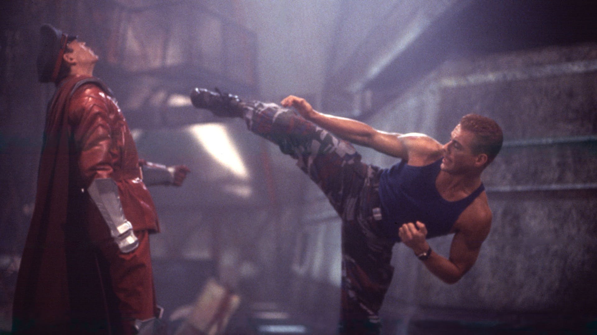 Colonel Guile delivering a powerful kick to Raul Julia’s General Bison in the film’s final showdown.