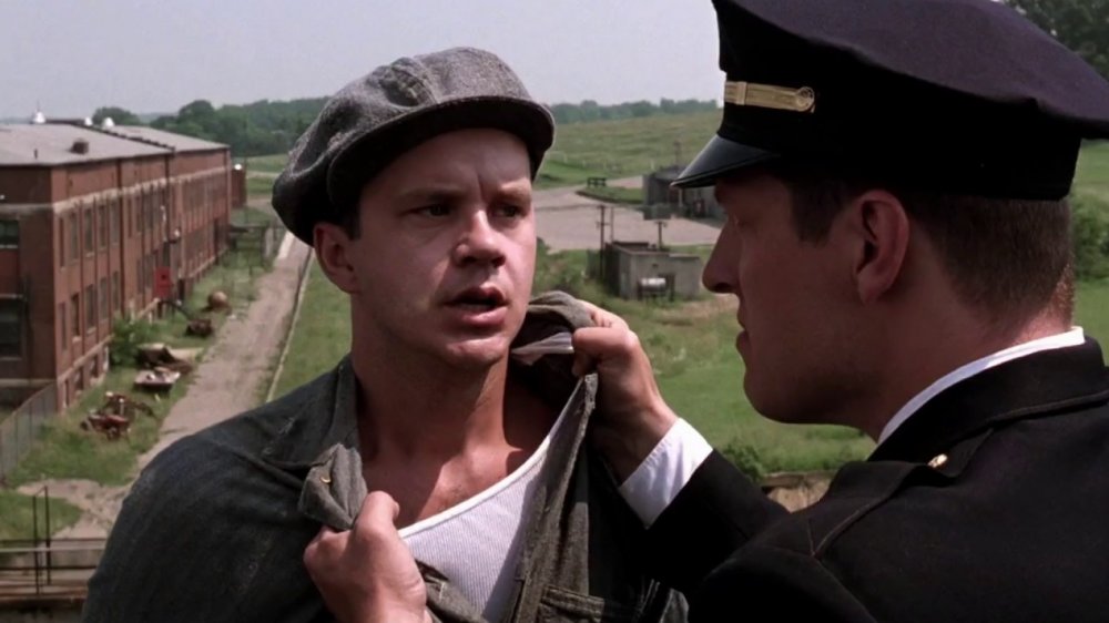 Tense moment from The Shawshank Redemption (1994) where Andy Dufresne (Tim Robbins) is grabbed by a prison guard